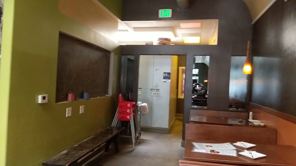 Outdoor seating area beside a busy street.
